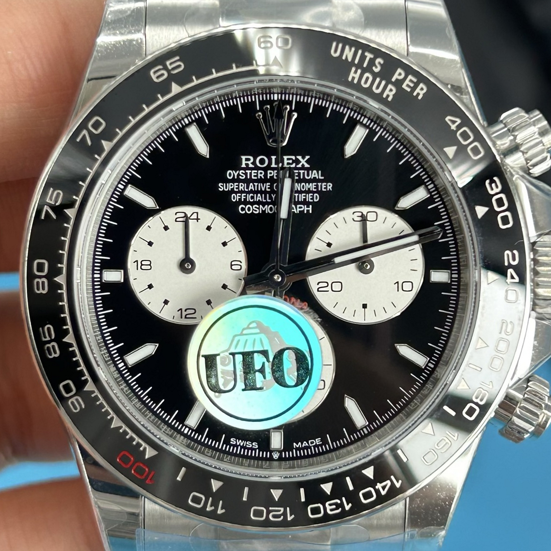 S007 · Camera geometry corrected. Image rotated approximately 1.4° clockwise at the dial centre; perspective and unequal image scaling normalized to a circular dial reference using isolated printed minute strokes. Recentered and resampled to 1900 × 1900 pixels. No correction for crystal refraction or raised bezel/hand geometry. Extended rays are visual dial references only; they do not correct or measure the raised bezel.