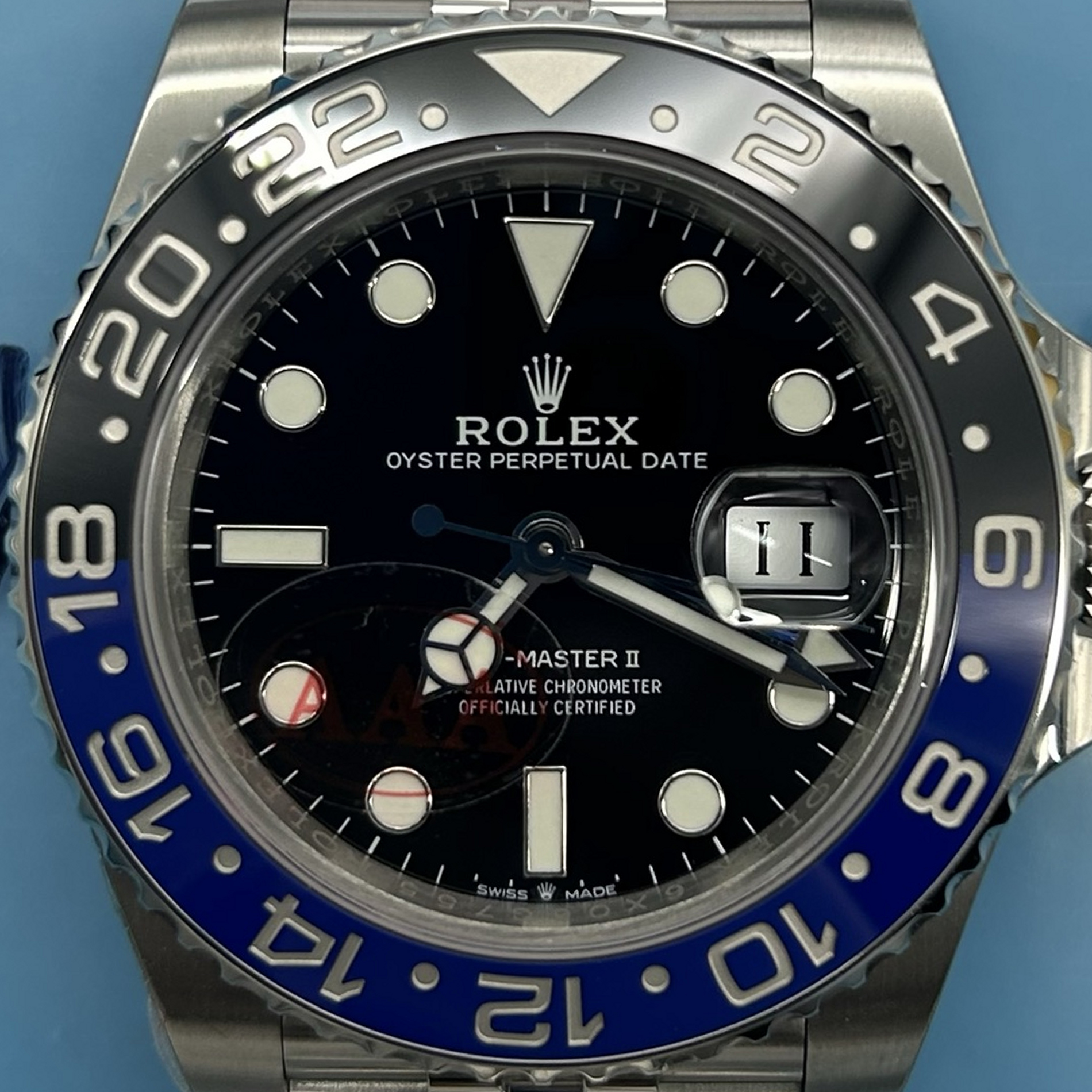 S002 · Camera geometry corrected. Image rotated approximately 0.4° clockwise at the dial centre; perspective and unequal image scaling normalized to a circular dial reference using isolated printed minute strokes. Recentered and resampled to 1900 × 1900 pixels. No correction for crystal refraction or raised bezel/hand geometry. Extended rays are visual dial references only; they do not correct or measure the raised bezel.