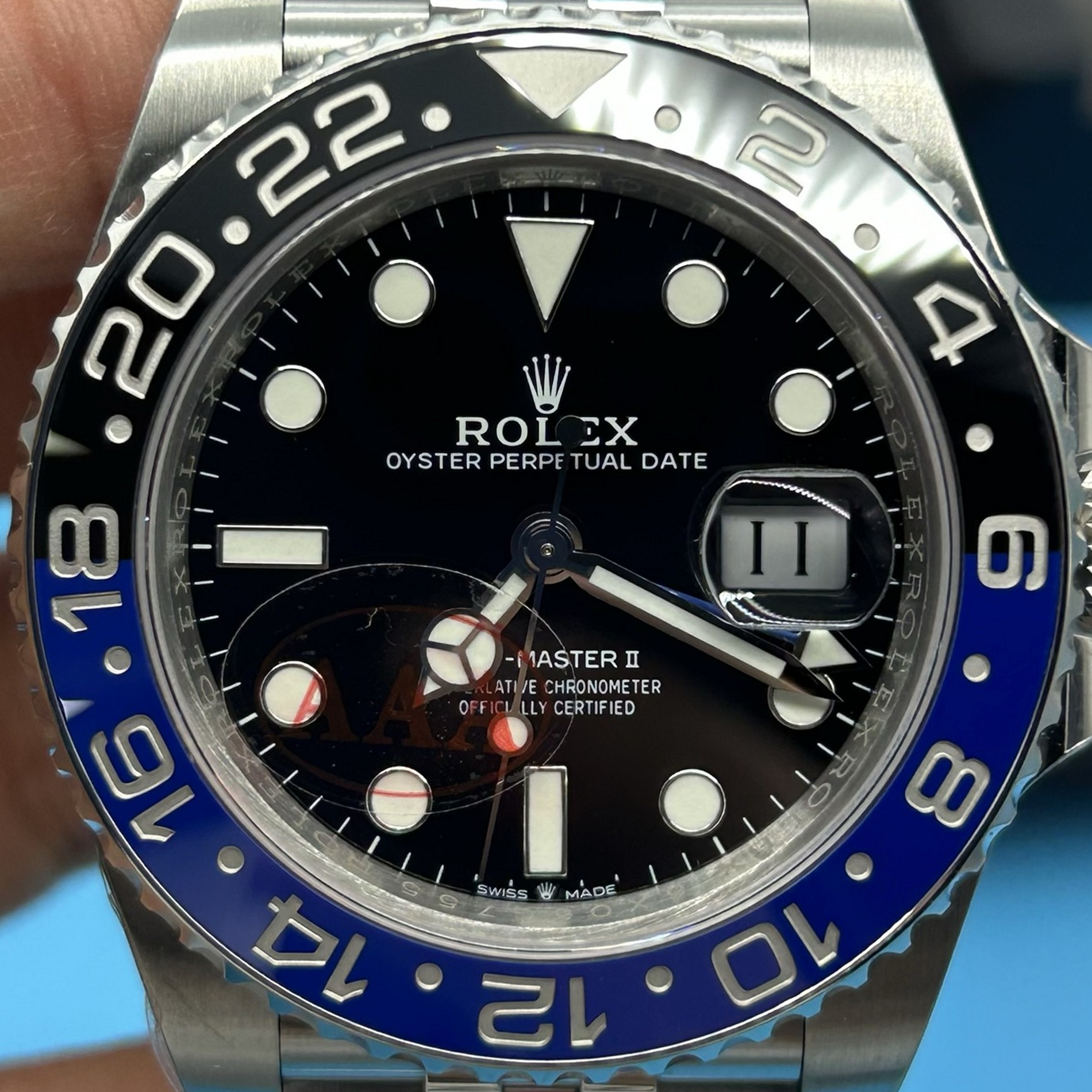 S007 · Camera geometry corrected. Image rotated approximately 0.9° clockwise at the dial centre; perspective and unequal image scaling normalized to a circular dial reference using isolated printed minute strokes. Recentered and resampled to 1900 × 1900 pixels. No correction for crystal refraction or raised bezel/hand geometry. Extended rays are visual dial references only; they do not correct or measure the raised bezel.